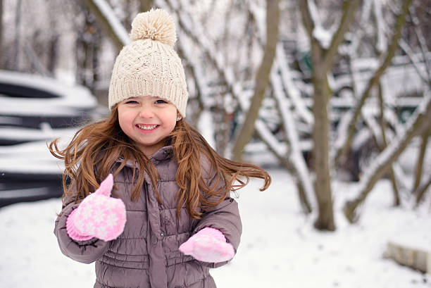 Winter little girl Smiling little girl enjoyig winter at home kids winter coat stock pictures, royalty-free photos & images