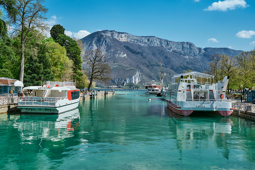 Haute-Savoie, France - Apr 14, 2022: Tourists boarding a boat at Lake Annecy on a sunny day.