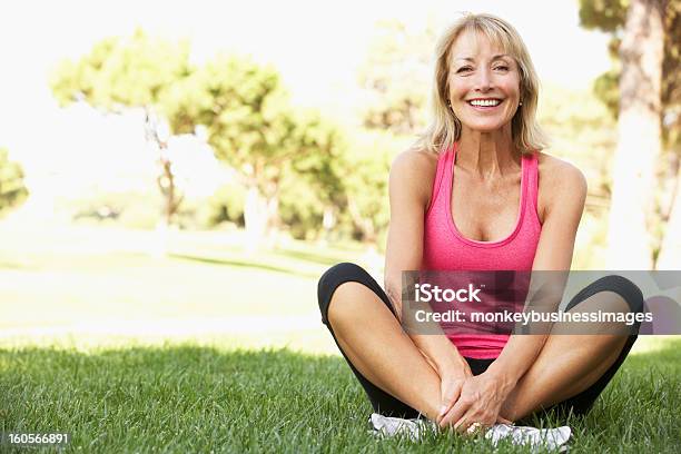 Senior Woman Resting After Exercising In Park Stock Photo - Download Image Now - Exercising, Senior Women, Women