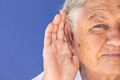Elderly woman with difficulty in hearing.