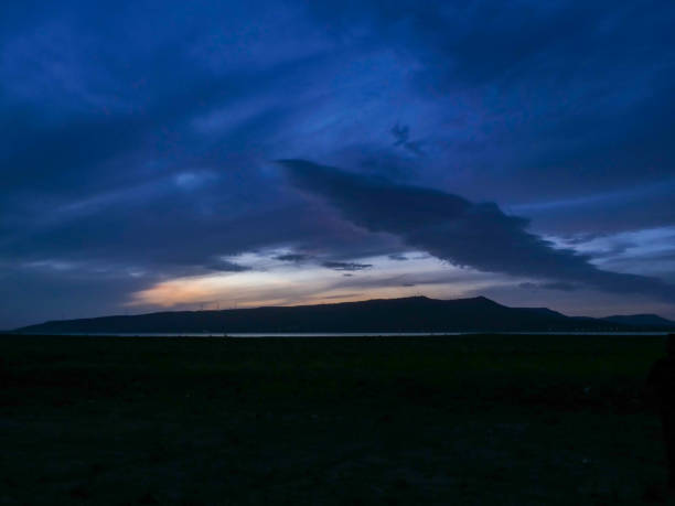 istock sunset over the mountains lake side 1605685910