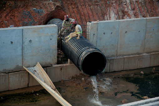 salvador, bahia, brazil - july 29, 2022: construction of sewage pipeline exclusive way for BRT transport system in the Lucaia canal region in the city of Salvador.