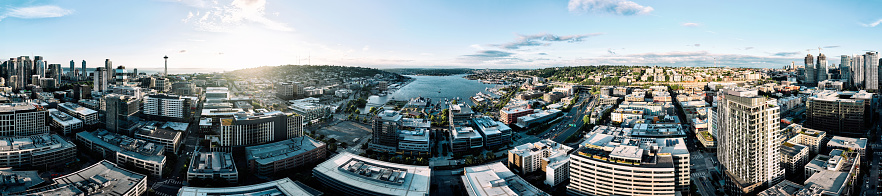 A panorama of aerial footage above Seattle, Washington, USA, the evening sun casting deep shadows on the city.