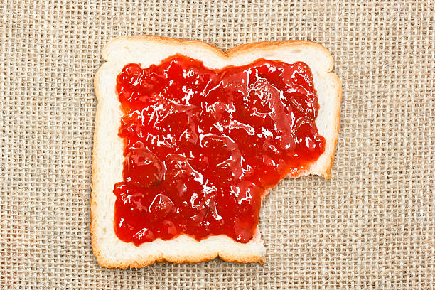 istock bited slice of bread with strawberry jam on sacking 160572084