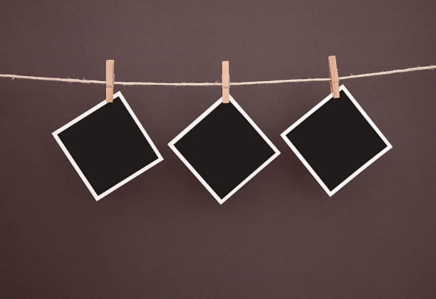 istock old blank photos hanging on clothesline with clipping path 160572520