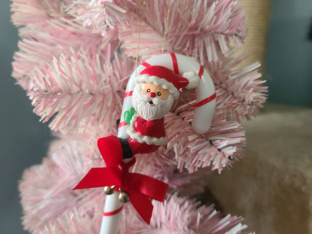 istock Santa on a Candy Cane Christmas Tree Ornament 1605762878