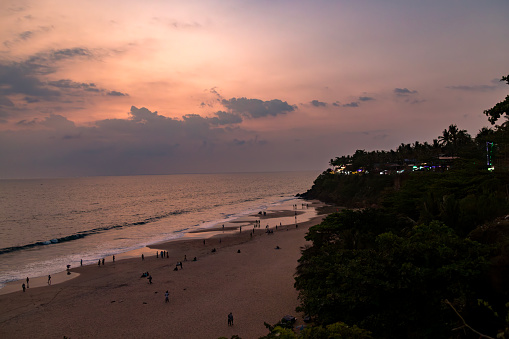 Kerala, India. Varkala beach at night, various cafes and restaurants at the cliff with colorful sunset sky .
