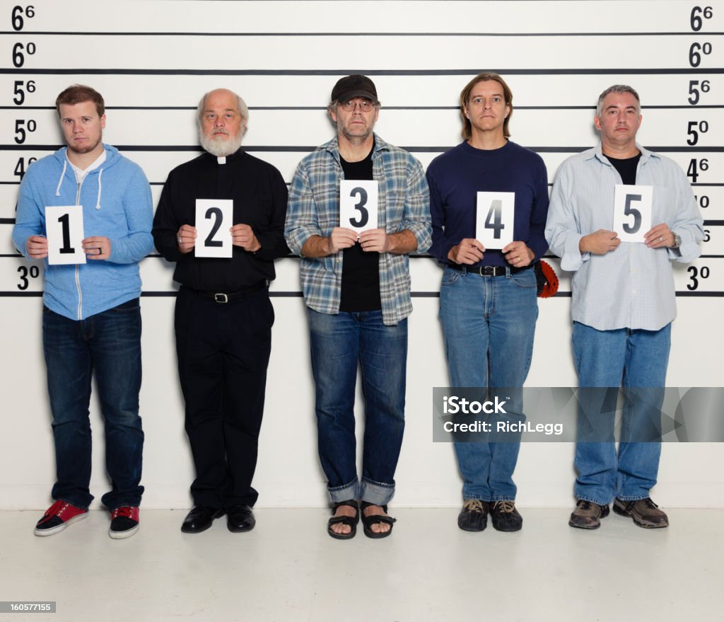 Men in a Police Lineup A group of men with a priest in a police line-up. Police Line-Up Stock Photo