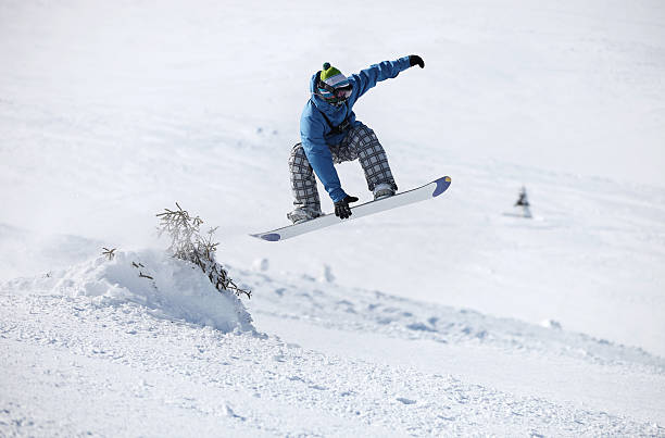 istock Snowboarder jumping on a snowy slope 160578583