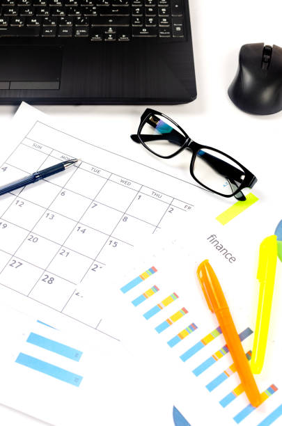istock Working set for analyzing statistics and results of last year. Charts and graph with financial data, laptop, glasses. 1605791735