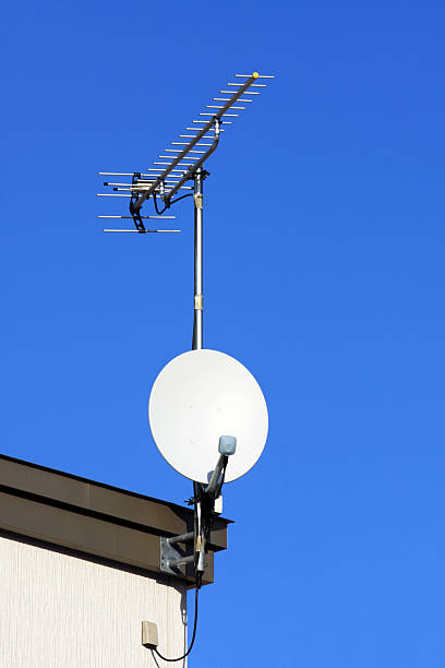 istock Satellite dishes and TV antenna on blue sky 160579415