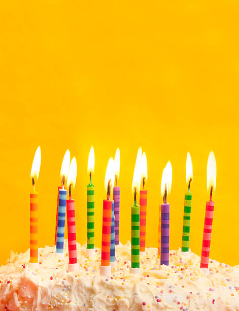 birthday cake on yellow background happy birthday cake shot on a yellow background with candles and lots of space birthday cake green stock pictures, royalty-free photos & images