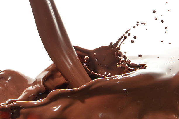 Chocolate milk pouring down from the top and splashing