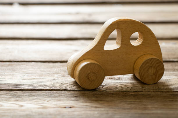 istock Small old wooden car on a wooden table 1605816440