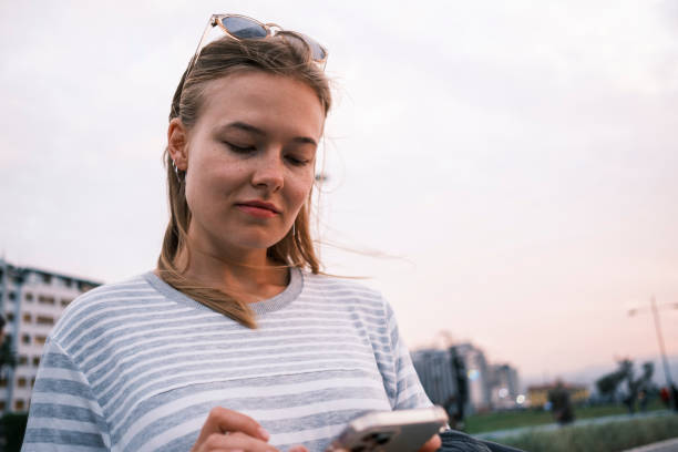 istock Caucasian girl checking her phone 1605822430