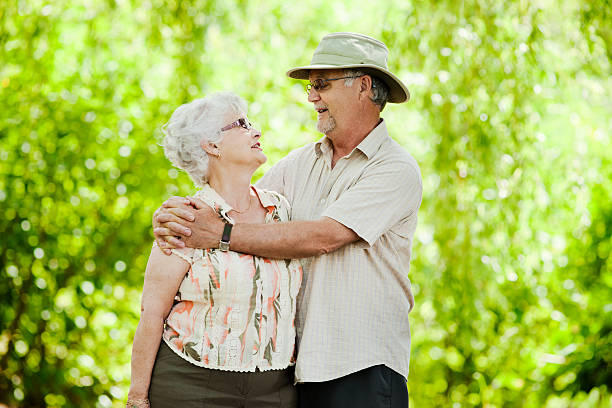 istock Senior Couple Embracing Under Weeping Willow 160582355