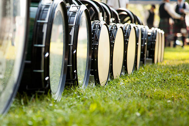 Drum Line on Ground A common sight around any Highland games or Pipe Band competition, the snare drums lined up on the ground, waiting for tuning. With some of the most difficult drumming rudiments in the world, the pipe band snare drum is one of the most difficult drums to master and requires a dedicated musician. bass drum photos stock pictures, royalty-free photos & images