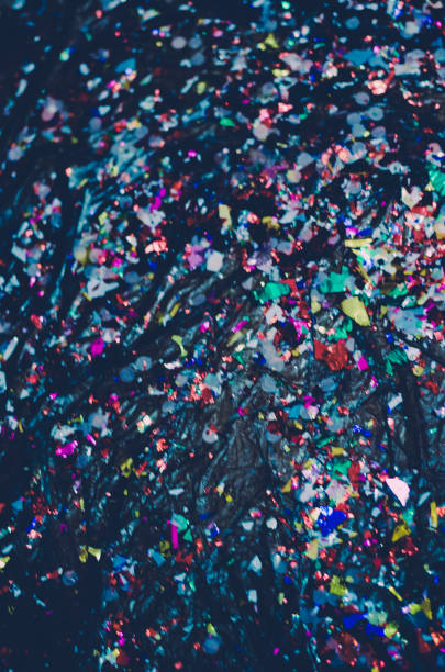 istock Blurry colorful confetti on dark surface 1605872158
