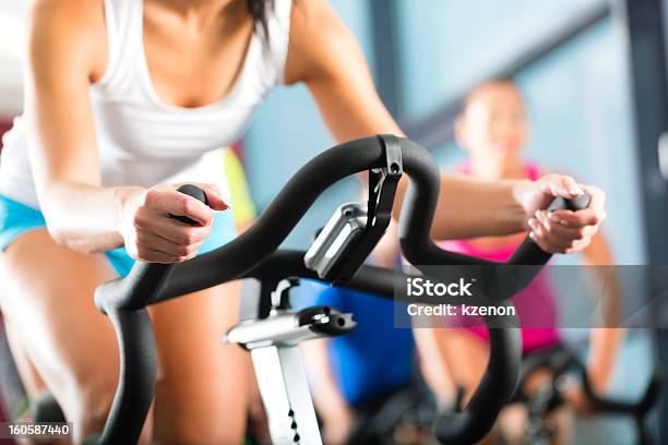 Young People Exercising In The Gym Stock Photo - Download Image Now - Spinning, Women, Cycling