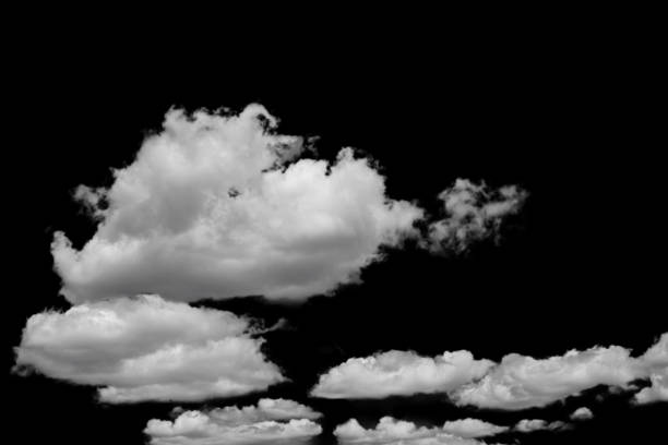 istock white fluffy clouds standing out against a black background and a blue sky 1605882094