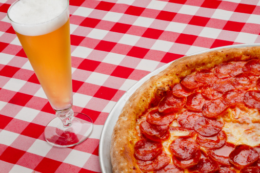 Pepperoni Pizza on Gingham table cloth with cold beer