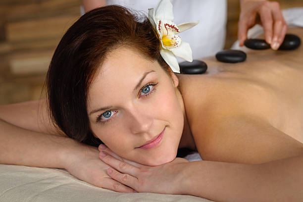 istock Woman enjoy hot lava stone massage spa 160590116