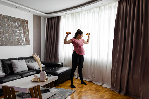 Pregnant woman exercising  at home