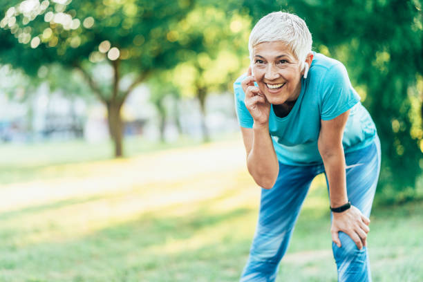 istock Senior woman jogging in the park 1605914789