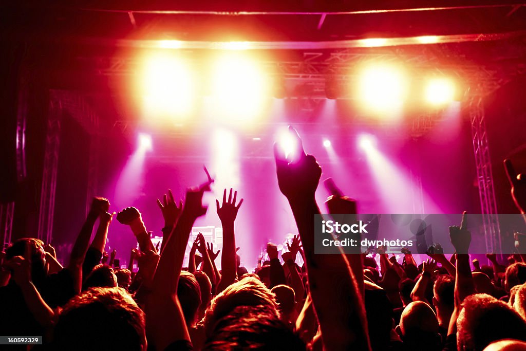 Concert crowd raising their arms in excitement Concert Crowd Admiration Stock Photo