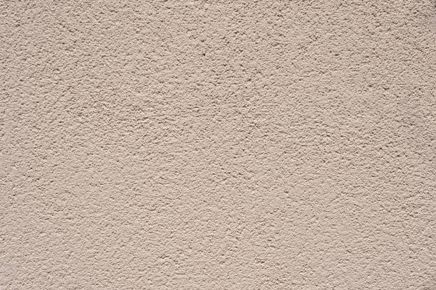 istock Neutral beige wall concrete plaster coating texture background, house room wall finishing decoration, aesthetic pattern design template 1605923440