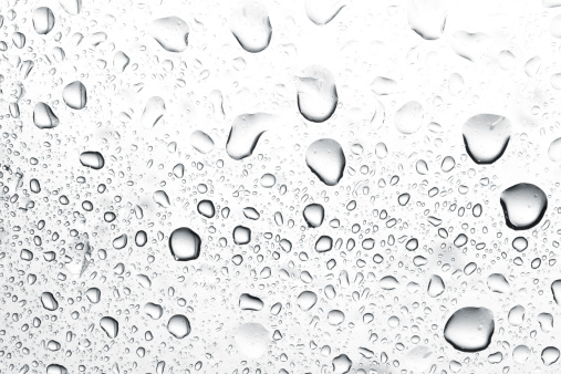 Close up of monochrome transparent air bubbles in water.