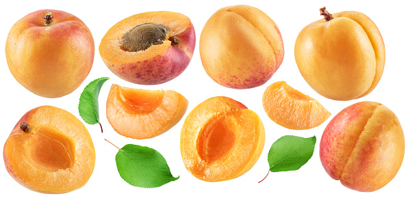 Set of ripe apricots and apricot slices on white background. File contains clipping paths.