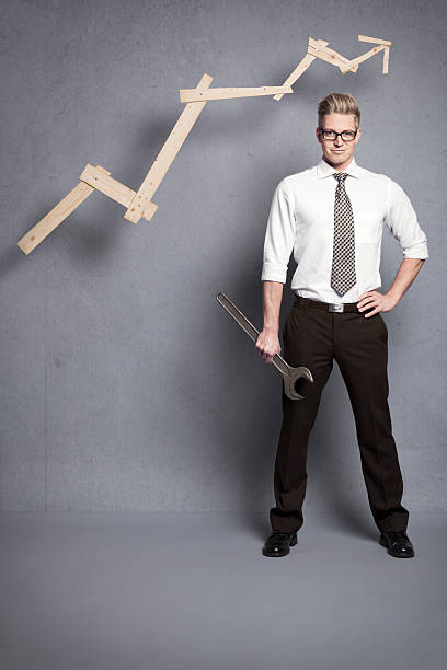 istock Confident businessman with wrench and graph. 160595993