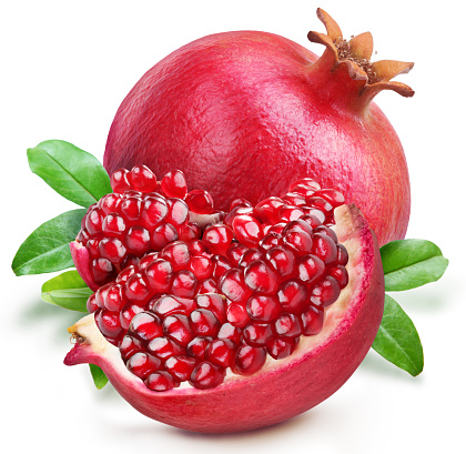 Ripe pomegranate fruit with leaves and cluster of pomegranate seeds isolated on white background.