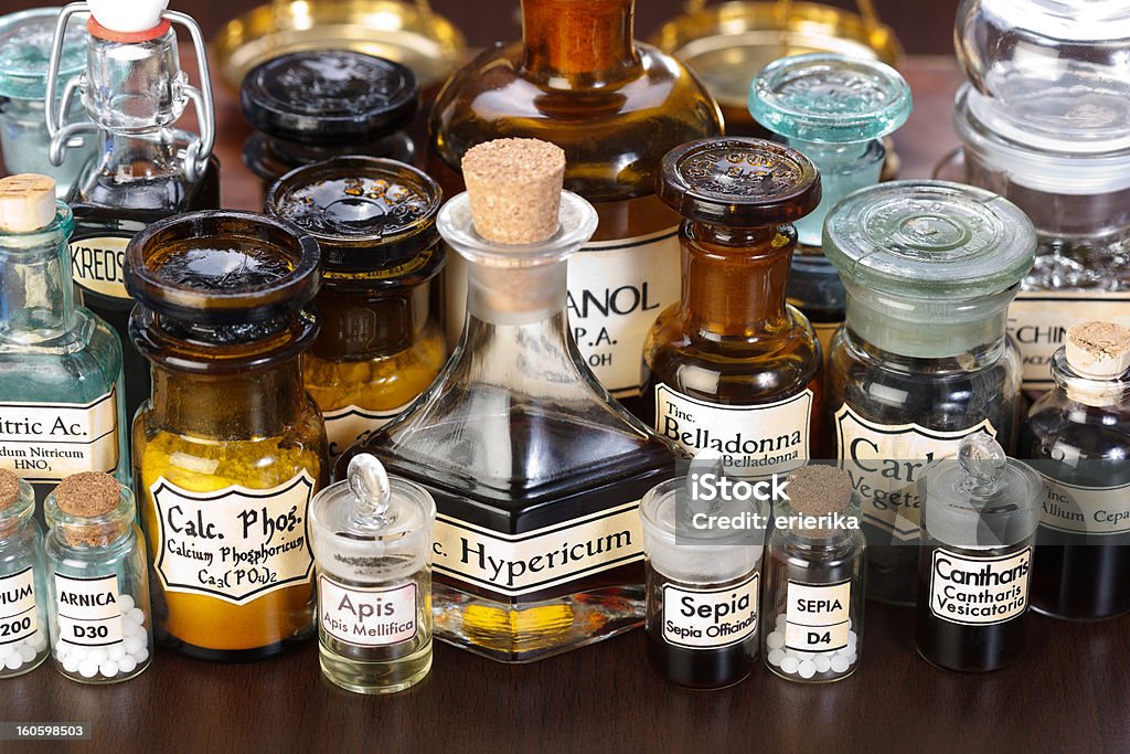 Various pharmacy bottles of homeopathic medicine Various pharmacy bottles of homeopathic medicine on dark background Homeopathic Medicine Stock Photo