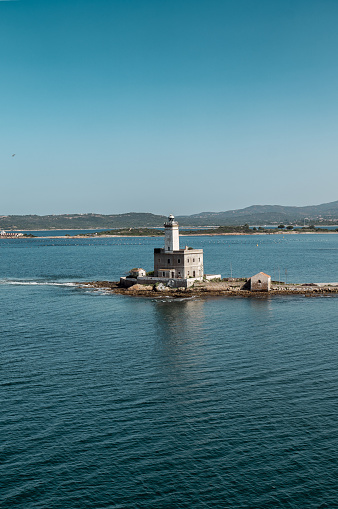 Standing vigil at the southern entrance of the outer Port of Olbia, the active Isola della Bocca Lighthouse (Faro di Isola della Bocca) graces a small islet just 250 metres (820 ft) from the Sardinian mainland. Located in the municipality of Olbia, this beacon remains an essential navigation mark on the shimmering waters of the Tyrrhenian Sea