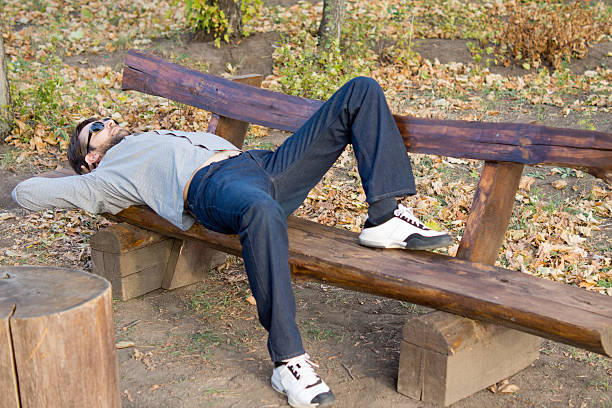istock Man asleep on a wooden bench 160602433