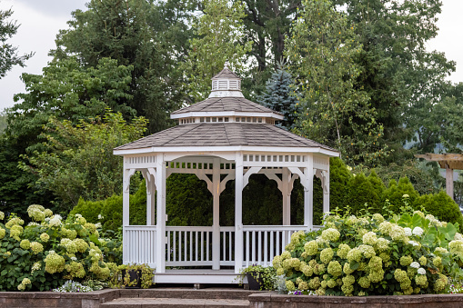 Landscape architecture featuring perennials and gazebo for backyard oasis
