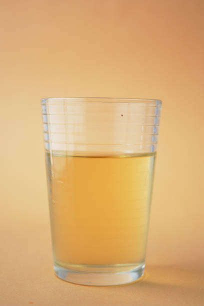 Young girl holding glass of beer.