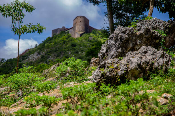 The Citadelle La Ferrière is a military structure built in the early 19th century at Milot in Haiti's North Department by Henri Christophe, president and later king of the country. It is the largest fortress on the American continent1 : at an altitude of 900 metres, it is located 15 km south of Cap-Haïtien, in the heart of the Citadelle, Sans Souci, Ramiers National Historic Park, a UNESCO World Heritage Site since 1982. The fortress could house a garrison of 2,000 men, rising to 5,000 in times of need. citadel haiti photos stock pictures, royalty-free photos & images