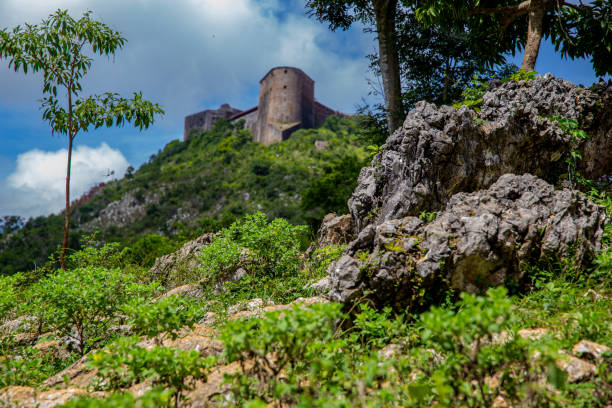 The Citadelle La Ferrière is a military structure built in the early 19th century at Milot in Haiti's North Department by Henri Christophe, president and later king of the country. It is the largest fortress on the American continent1 : at an altitude of 900 metres, it is located 15 km south of Cap-Haïtien, in the heart of the Citadelle, Sans Souci, Ramiers National Historic Park, a UNESCO World Heritage Site since 1982. The fortress could house a garrison of 2,000 men, rising to 5,000 in times of need. citadel haiti photos stock pictures, royalty-free photos & images