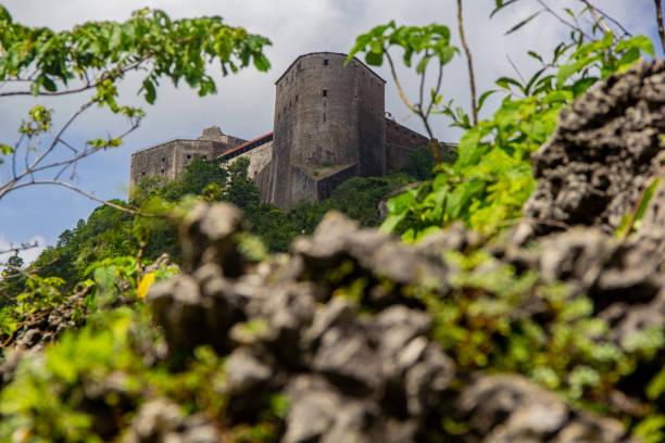 The Citadelle La Ferrière s a military structure built in the early 19th century at Milot in Haiti's North Department by Henri Christophe, president and later king of the country. It is the largest fortress on the American continent1 : at an altitude of 900 metres, it is located 15 km south of Cap-Haïtien, in the heart of the Citadelle, Sans Souci, Ramiers National Historic Park, a UNESCO World Heritage Site since 1982. The fortress could house a garrison of 2,000 men, rising to 5,000 in times of need. citadel haiti photos stock pictures, royalty-free photos & images