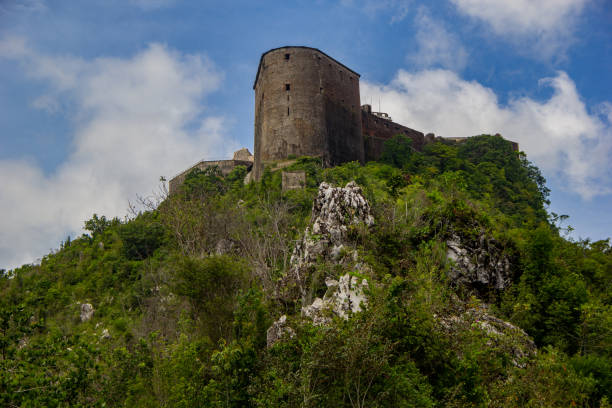 The Citadelle La Ferrière Is a military structure built in the early 19th century at Milot in Haiti's North Department by Henri Christophe, president and later king of the country. It is the largest fortress on the American continent1 : at an altitude of 900 metres, it is located 15 km south of Cap-Haïtien, in the heart of the Citadelle, Sans Souci, Ramiers National Historic Park, a UNESCO World Heritage Site since 1982. The fortress could house a garrison of 2,000 men, rising to 5,000 in times of need. citadel haiti photos stock pictures, royalty-free photos & images