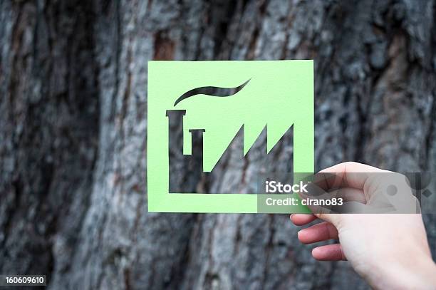 Hand Holding Green Factory Against Bark Tree Stock Photo - Download Image Now - Building - Activity, Building Exterior, Built Structure