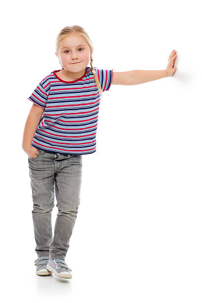 istock Little girl leaning against a white wall. 160611154