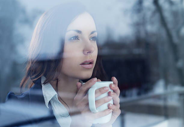 istock Young woman looking through the window 160611744