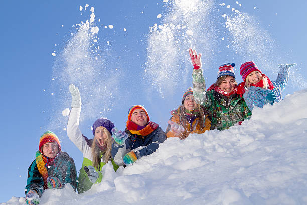 istock Group of happy people lying on hill playing with snow 160612856