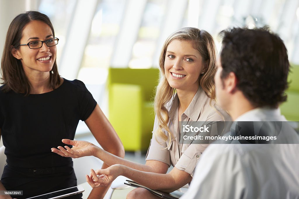 Businesspeople Having Meeting Around Table Businesspeople Having Meeting Around Table In Modern Office Discussion Stock Photo