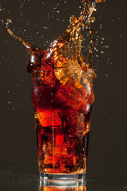 istock Full Pint of Cola with big ice cube splash 160615036