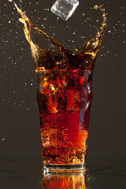 istock Full Pint of Cola with big ice cube splash 160616123